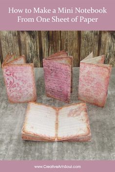 an open book sitting on top of a table next to some pink books with the title how to make a mini notebook from one sheet of paper