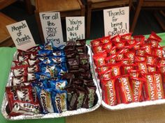 two trays filled with candy sitting on top of a table next to each other