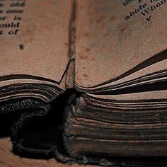 an open book sitting on top of a wooden table