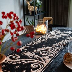 the table is decorated with red flowers and placemats for dinner guests to enjoy