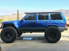 a blue suv parked on top of a parking lot