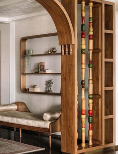 an arch in the living room is made out of wood and decorated with colorful beads