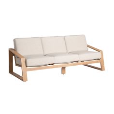 a wooden couch with white cushions sitting on top of it's backrests