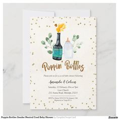 a baby shower is shown with gold confetti on the bottle and greenery