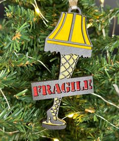 a christmas ornament hanging on a tree with the word fragile in red and yellow