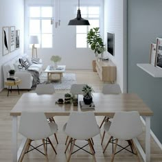 a living room with white furniture and wood flooring is pictured in this image, there are several chairs around the table