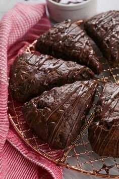 chocolate brownies on a wire rack next to a bowl of ice cream