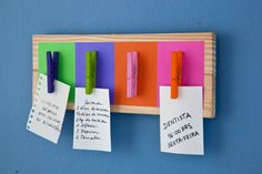 several pieces of paper pinned to a bulletin board with sticky notes attached to the pegs