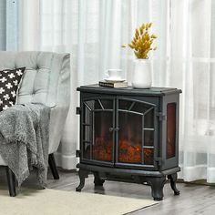 a living room with a couch, chair and fire place in front of a window