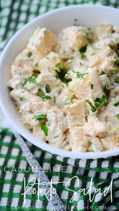 a white bowl filled with chicken salad on top of a green and white checkered table cloth