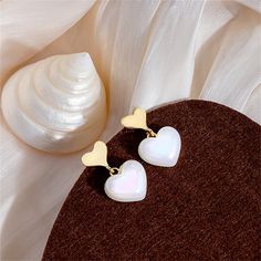 Gleaming pearls and bright 18k gold-plated metal meet in this shimmery drop earring pair featuring a classic heart motif. 0.62" W x 1.06" L 18k gold-plated copper / pearl Copper Pearl, Heart Motif, Heart Drop Earrings, Drop Earring, Gold Tones, 18k Gold, Gold Plate, Copper, Plating