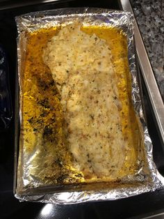 a pan filled with food sitting on top of a stove