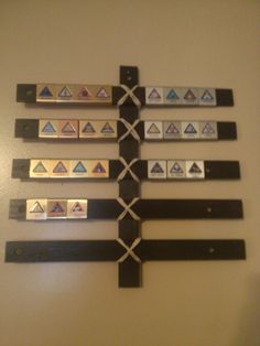 a wall with several different types of magnets attached to it's sides and hanging on the wall