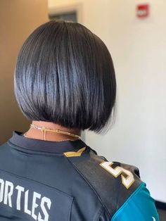 the back of a woman's head wearing a jersey that says turtles