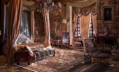 an ornate bedroom with four poster bed, chandelier and antique furniture in it