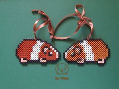 two pieces of bead art with dogs on them, one is orange and the other is white