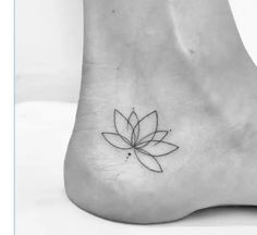 a small lotus flower tattoo on the side of someone's foot and it looks like they