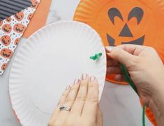 someone is decorating a paper plate for halloween