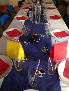 the table is set with place mats, plates and cups for children's birthday party