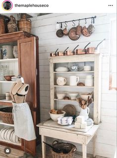 a wooden shelf filled with lots of dishes and baskets on top of it's sides