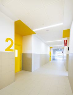 an empty hallway with yellow and white walls