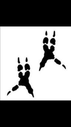 two black and white silhouettes of dogs paw prints