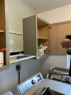 a man is standing in front of the washer and dryer that are being installed