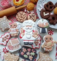 many decorated cookies and pastries on a table