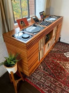 an old record player on top of a wooden cabinet