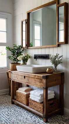 a bathroom with a sink, mirror and basket on the floor next to a window