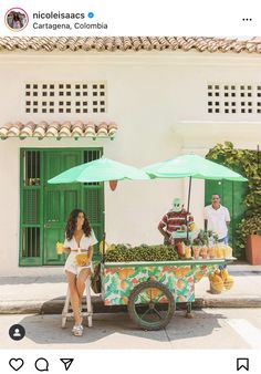 a woman standing next to a fruit cart