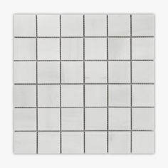 a white tiled wall with black dots on the bottom and one line in the middle