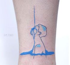 a small tattoo on the ankle of a woman's leg with a blue line drawing of a kissing couple