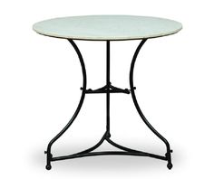 a white marble top table with wrought iron base and black metal frame, on an isolated white background