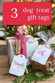 three dog treat gift tags on a table with christmas tree in the background and gifts wrapped in cellophane