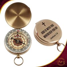 a compass keychain with an inspirational quote on the front and back, sitting next to a pocket watch