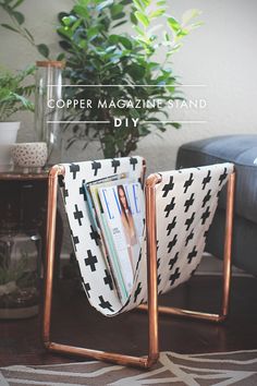 a magazine rack sitting on top of a wooden table next to a black and white couch