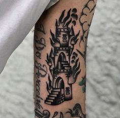 a man's arm with a castle tattoo on it