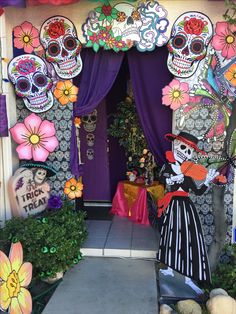 an entrance decorated with sugar skulls and flowers