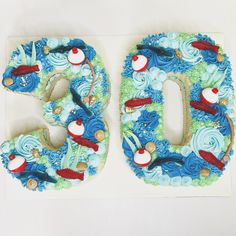 the letters are made out of fondant and decorated with colorful birds, waves, and swirls