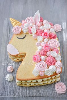 a cake shaped like a unicorn with pink and white frosting