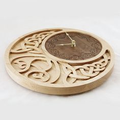 a wooden clock with an intricate design on the face