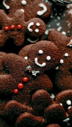 some very cute looking cookies with red and white candies on it's faces