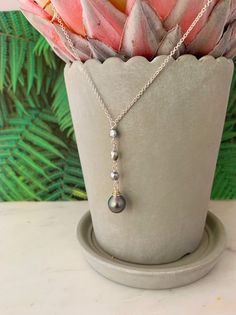 Looking for something unique and different. This beautiful necklace displays a nice and small Tahitian Pearl paired with small and dainty Tahitian keshis pearls . ✨Necklace length : 17-18” if you need a different size please specify at checkout . There is an extender on the back to make it more versatile and can be adjusted slightly ,about 1” . ✨Pendant length: approximately 2 inches.✨Tahitian pearl :Size : 8-9mm small and dainty size Shape : Tear dropColor : Color may varyQuality : Good overall Long Drop Pearl Charm Necklace As Gift, Long Drop Pearl Charm Necklace For Gift, Gift Long Drop Pearl Charm Necklaces, Silver Single Strand Teardrop Necklace, Silver Teardrop Single Strand Necklace, Tahitian Pearl Drop Necklace As Gift, Tahitian Pearl Drop Necklace For Gift, Handmade Tahitian Pearl Necklace Gift, Tahitian Pearl Briolette Necklace For Gifts