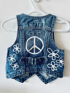 This is a one of a kind hand painted denim vest. Originally from H&M, this girl's vest features a cute buckle on the back, two butterfly patches on the front and removable buttons! Y2k Style Cotton Denim Vest For Spring, Y2k Cotton Denim Vest For Spring, Blue Y2k Style Vest For Spring, Fitted Cotton Denim Vest Y2k Style, Trendy Denim Vest For Spring Festival, Y2k Blue Denim Vest For Spring, Blue Y2k Denim Vest For Spring, Painted Denim Vest, Embroidered Denim Dress