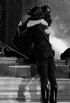 black and white photograph of two people hugging on steps