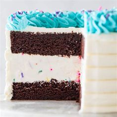 a close up of a slice of cake with frosting and sprinkles