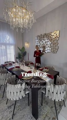 a dining room table with chairs and a chandelier hanging from the ceiling