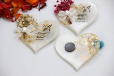 three heart shaped favors with flowers on them