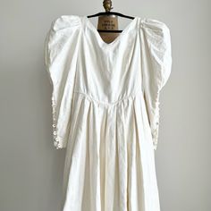 a white dress hanging on a hanger